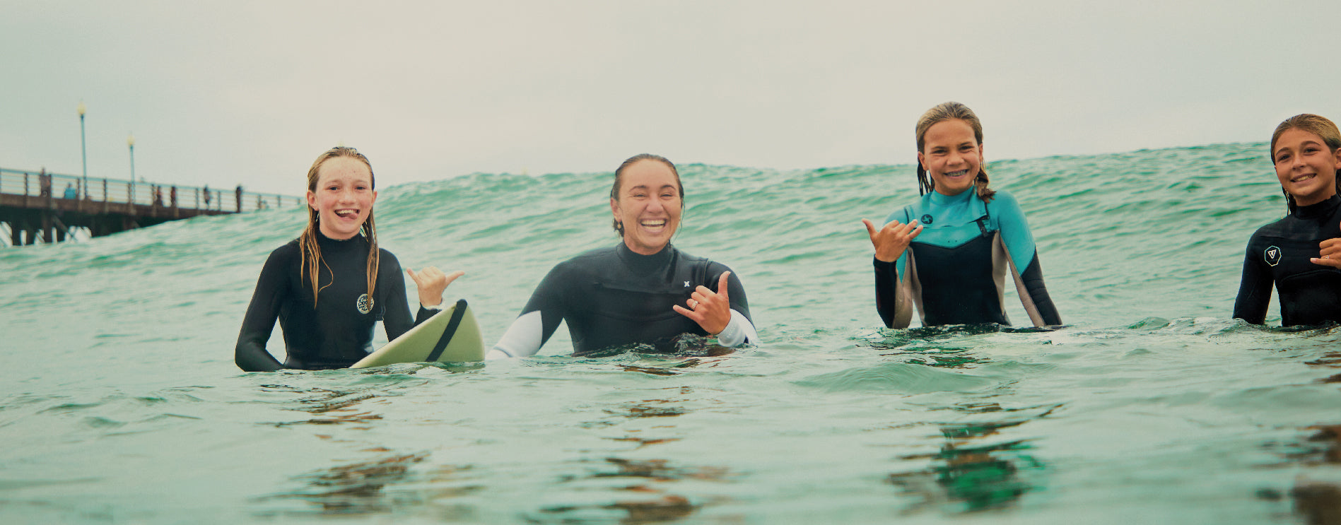 Carissa Moore in the water with three girls