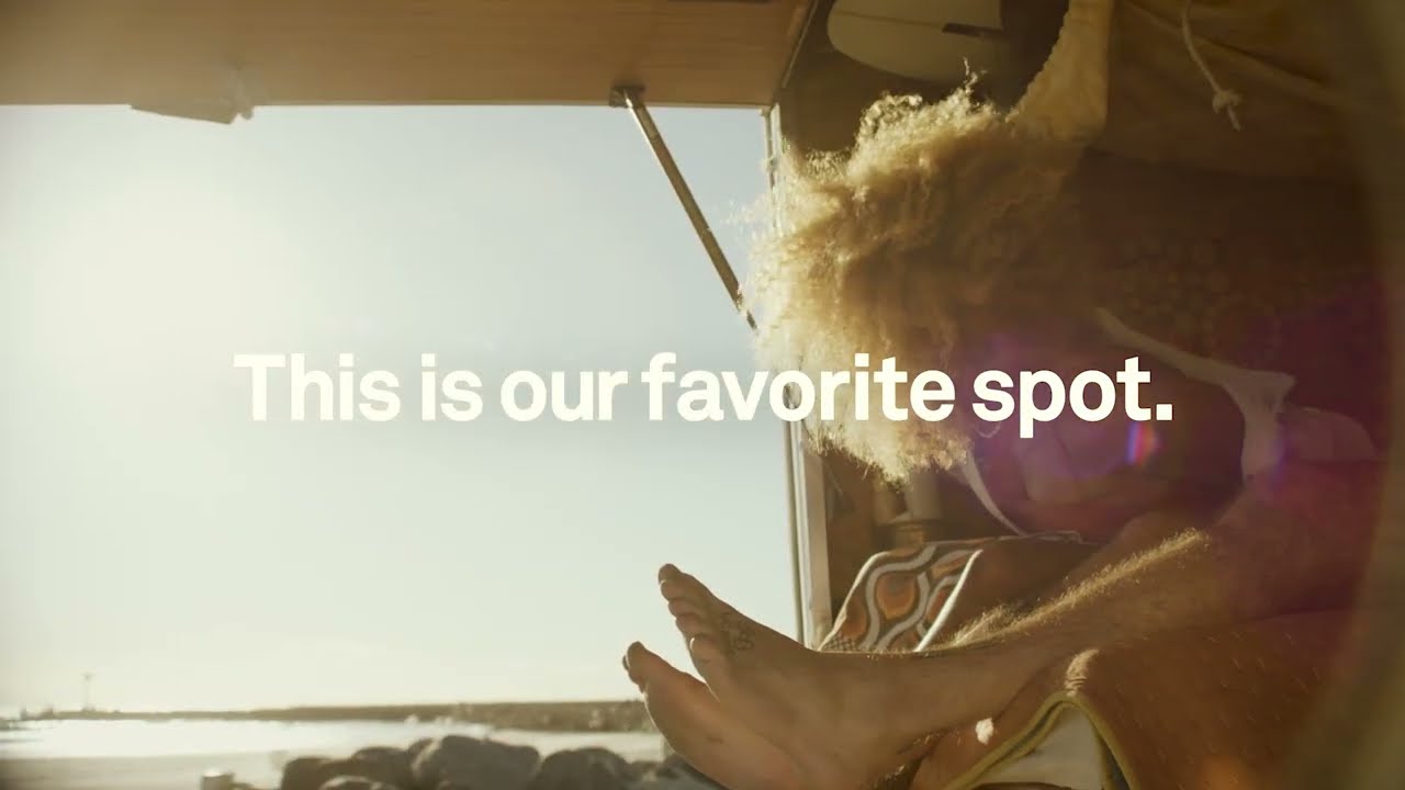 Person with a beard and sunglasses sitting inside a vehicle, with text 'This is our favorite spot.'
