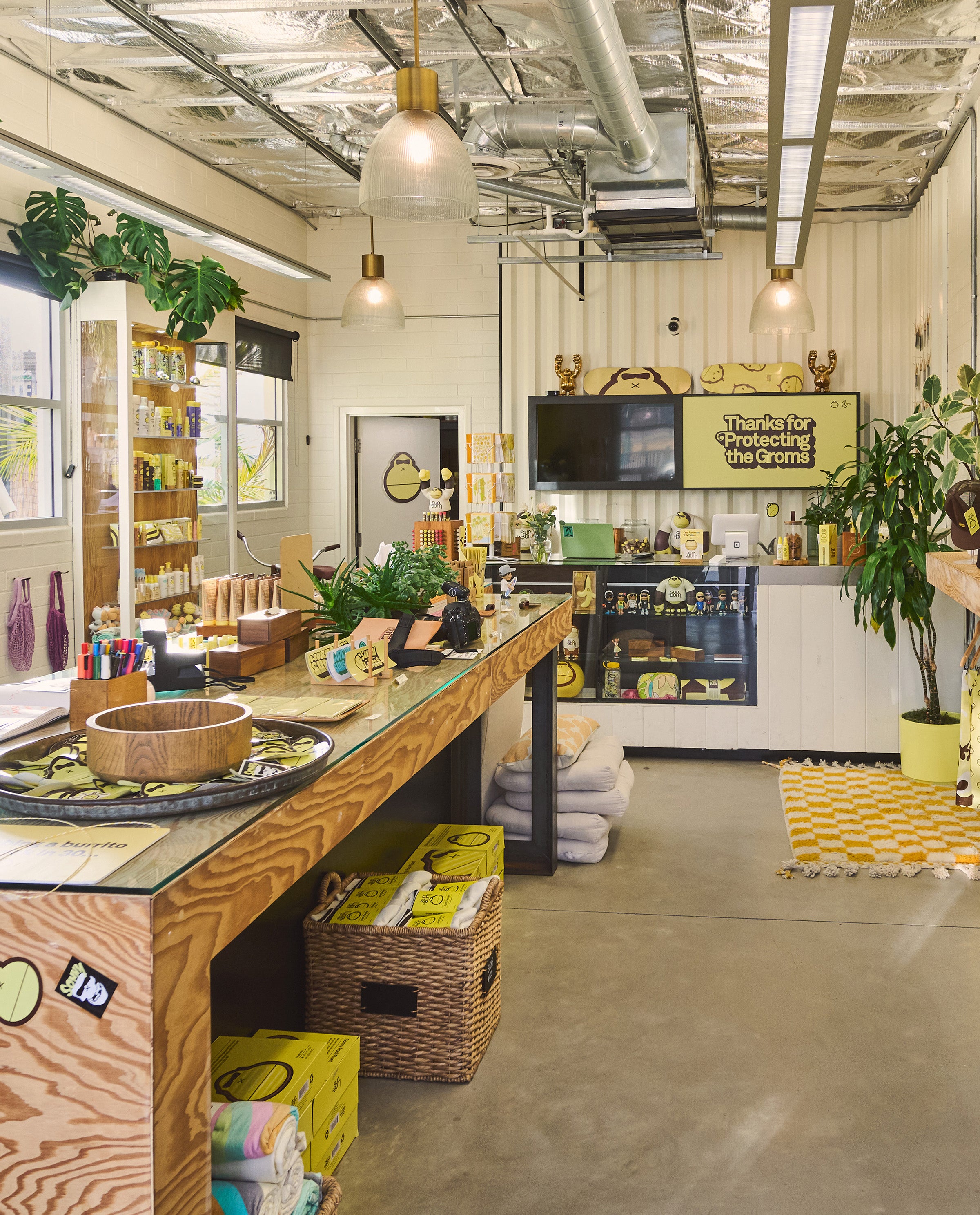 Bright, cozy Sun Bum store interior with beachy decor, product displays, and plants - Ask The Bum collection - Sun Bum