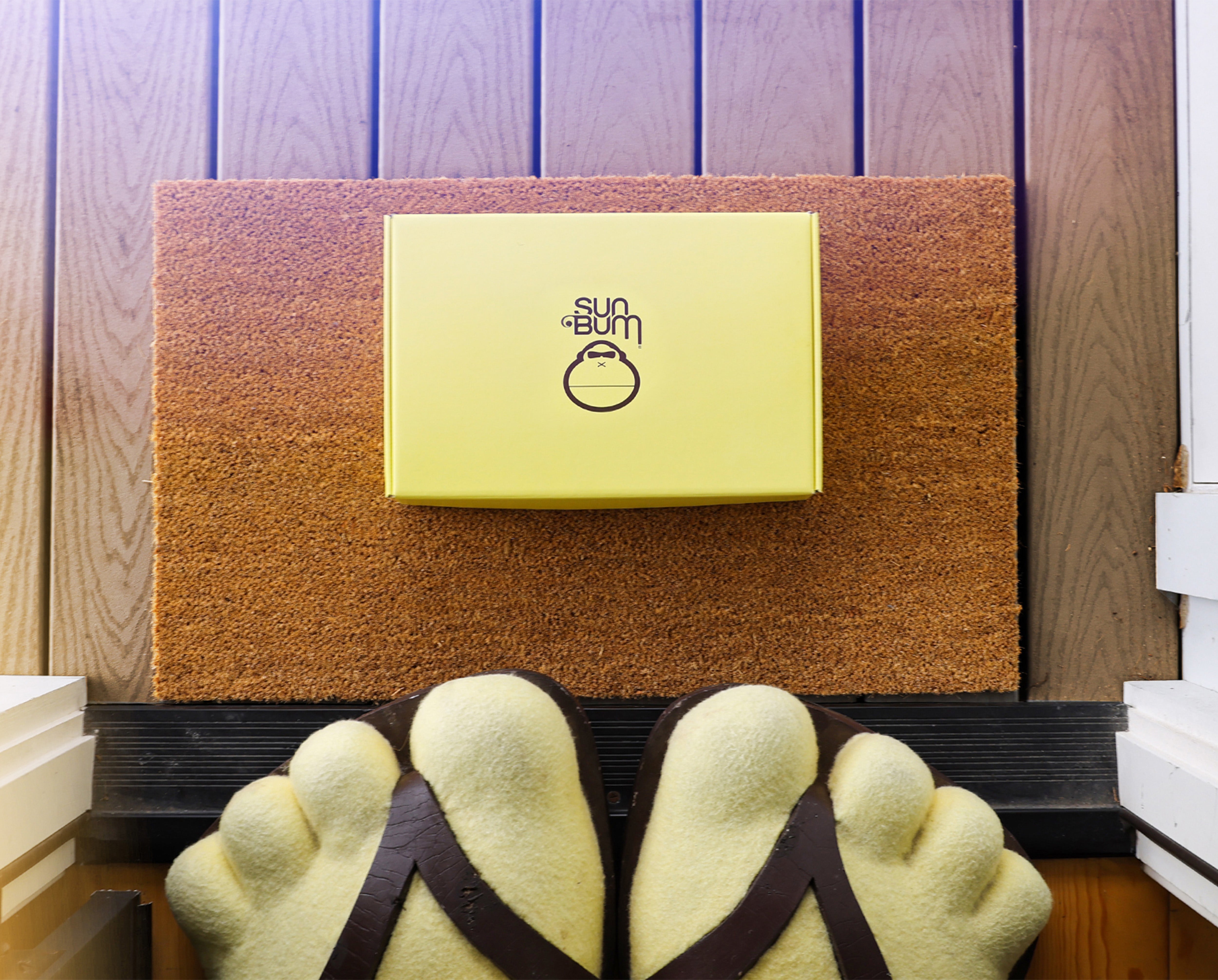 Doormat with a brand logo on a wooden floor