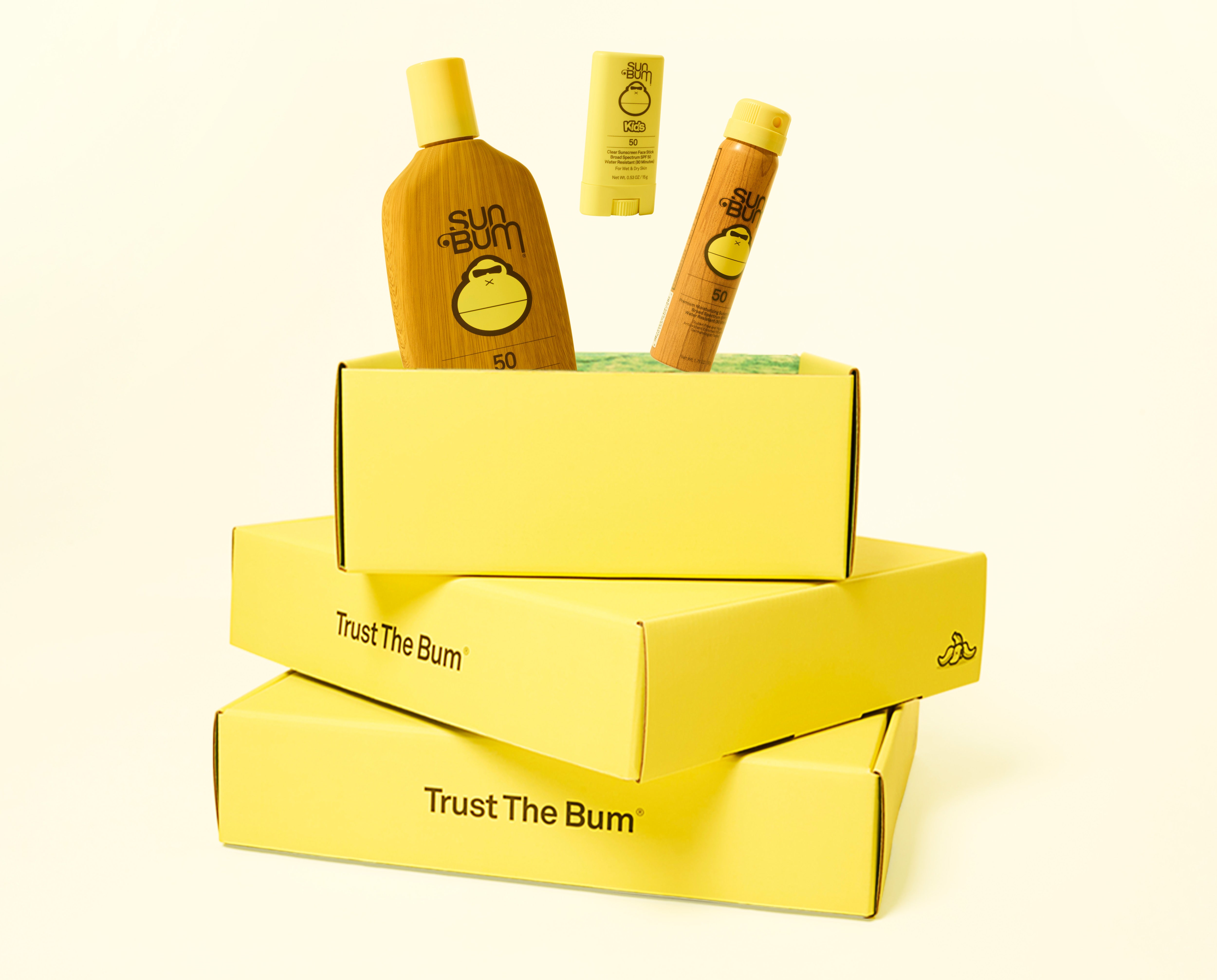 Yellow boxes with Sun Bum products on a white background